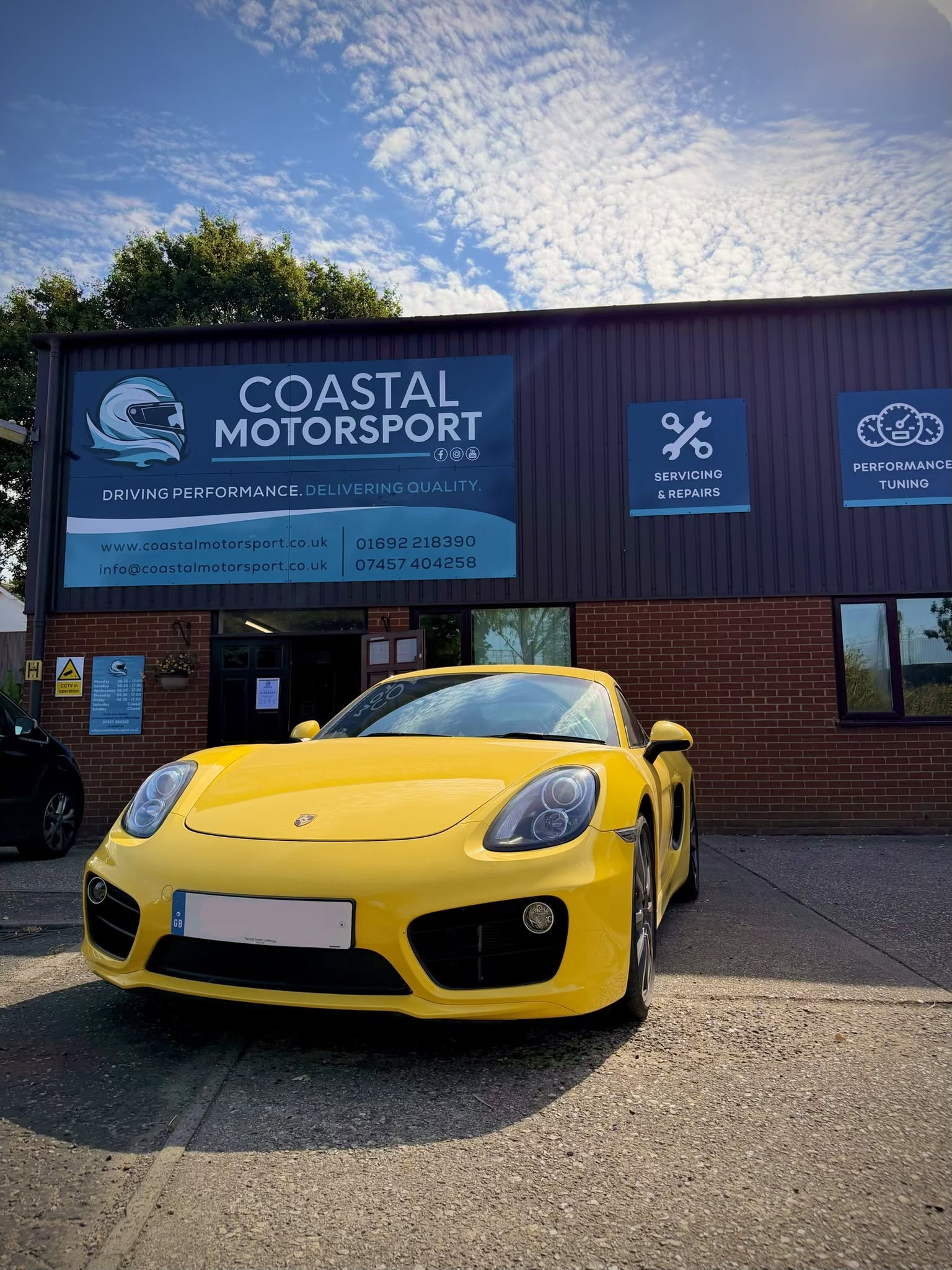 Yellow Porsche outside Coastal Motorsport
